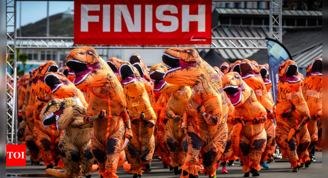 More than 500 UK runners set unofficial record with giant T-rex charity run – Times of India